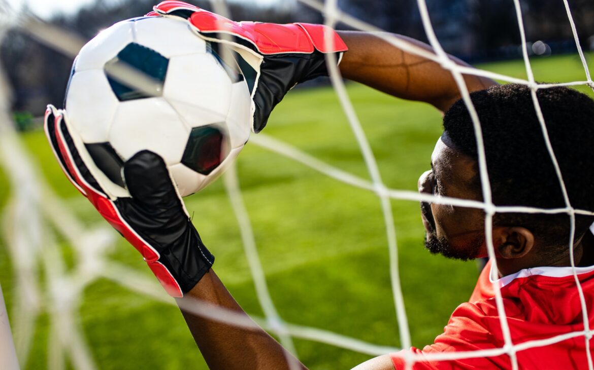 brazilian man goalkeeper catches the ball in the stadium during a football training